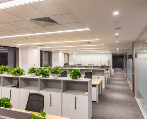 Corridor in modern style office. Empty tables, chairs and lockers