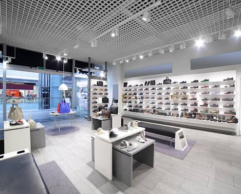 bright and fashionable interior of shoe store in modern mall