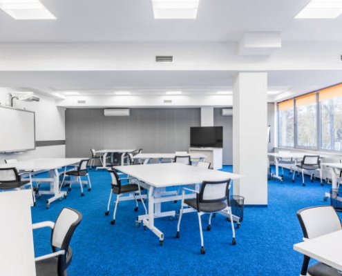Modern university group study room with white desks and chairs